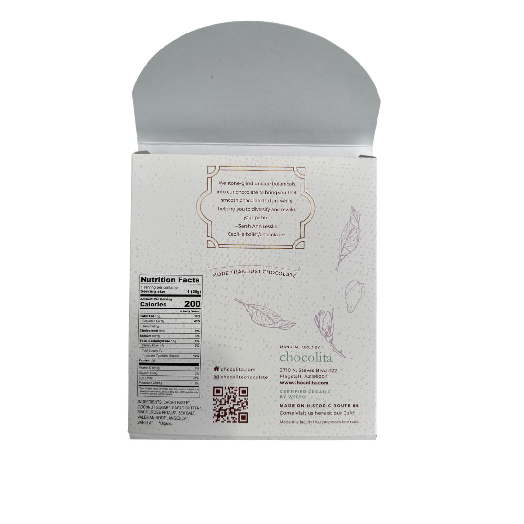 The back of an EASE- Moontime Rose by chocolita.com box shows nutrition facts, hormone-balancing female cycle herbs ingredients, company contact info, a chocolate quote, and is decorated with light cacao leaf illustrations.