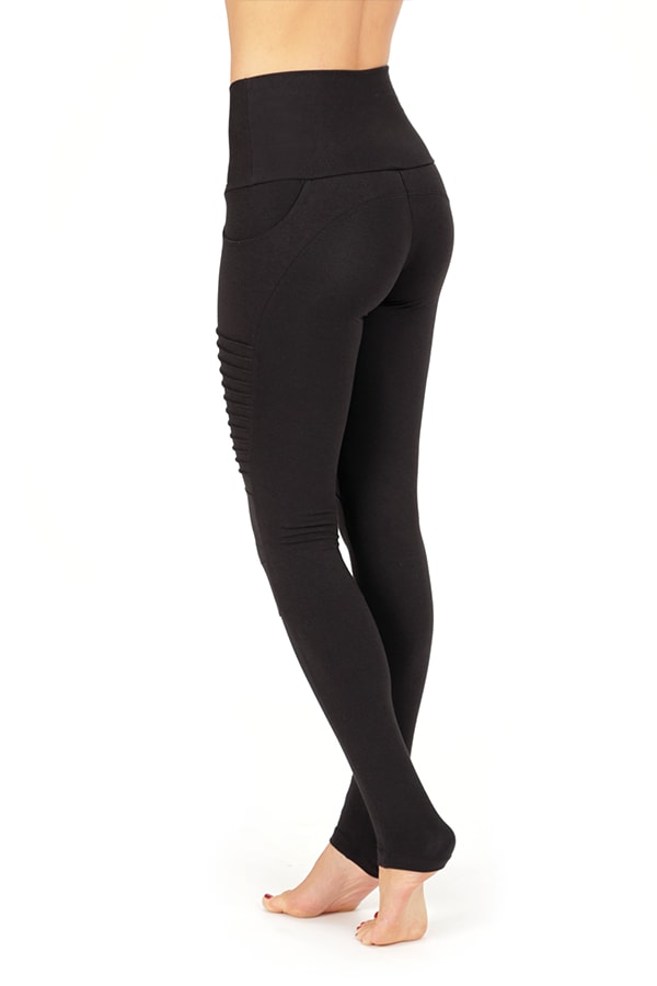 A person stands barefoot, shown from the back against a plain white background, wearing Melodia Designs’ Moto Xtreme Pocket Legging—high-waisted with eco-luxe fabric and ribbed side detailing.