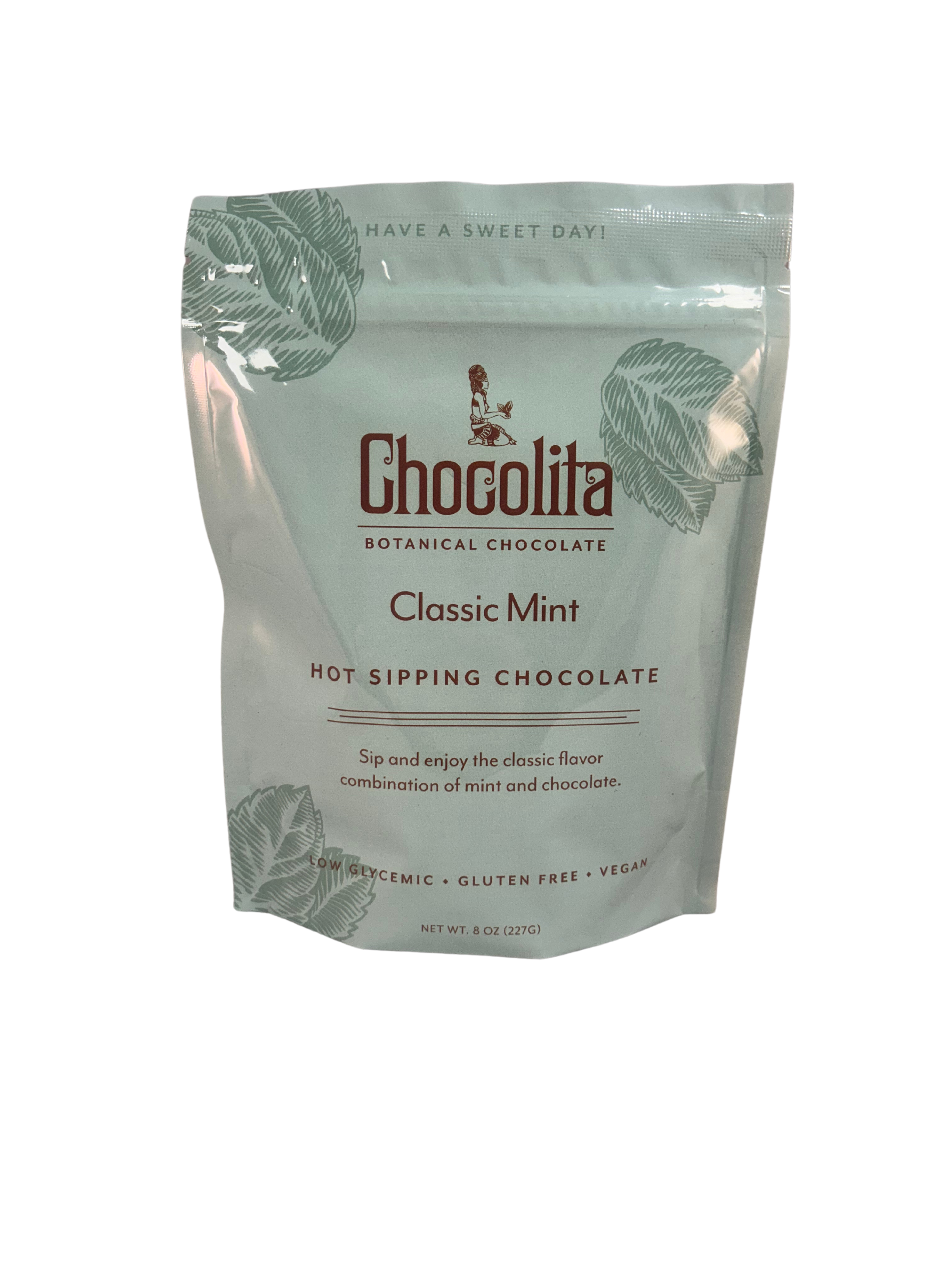 A light green resealable bag of chocolita.com Exotic Mint Sipping Chocolate, decorated with mint leaf illustrations and product info highlighting its mint chocolate flavor and low-glycemic, vegan sipping chocolate qualities.