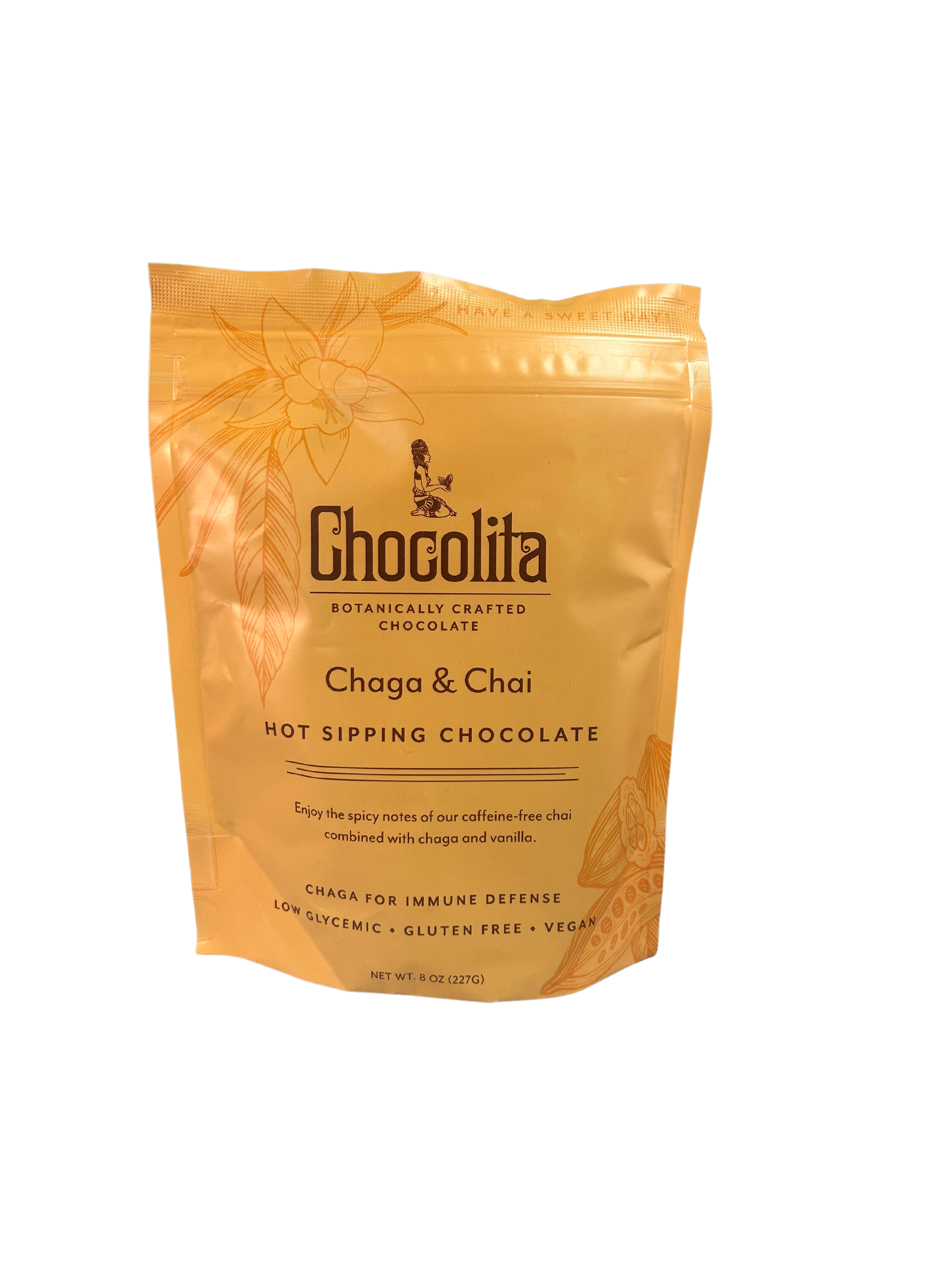 A yellow-orange pouch from chocolita.com, labeled Chaga & Chai Sipping Chocolate, features floral designs and highlights its caffeine-free chai, low glycemic index, gluten-free, vegan profile—a delicious sipping chocolate with a unique chaga twist.