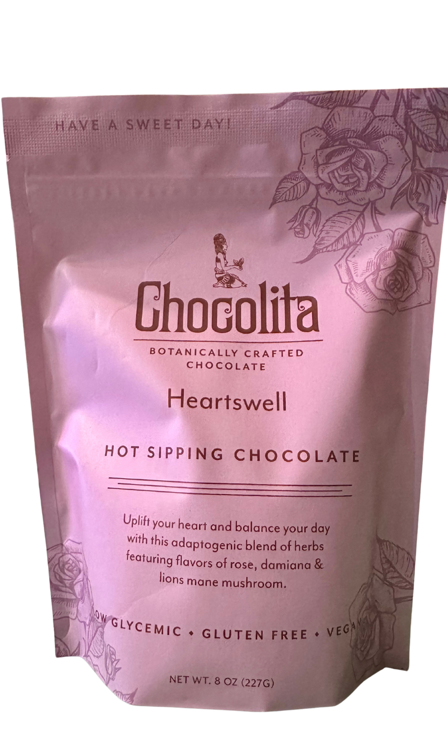 A pink resealable pouch of chocolita.com Heartswell Sipping Chocolate with floral designs, adaptogenic heart-opening herbs, low glycemic index, gluten-free and vegan features. Net weight: 8 oz (227g).