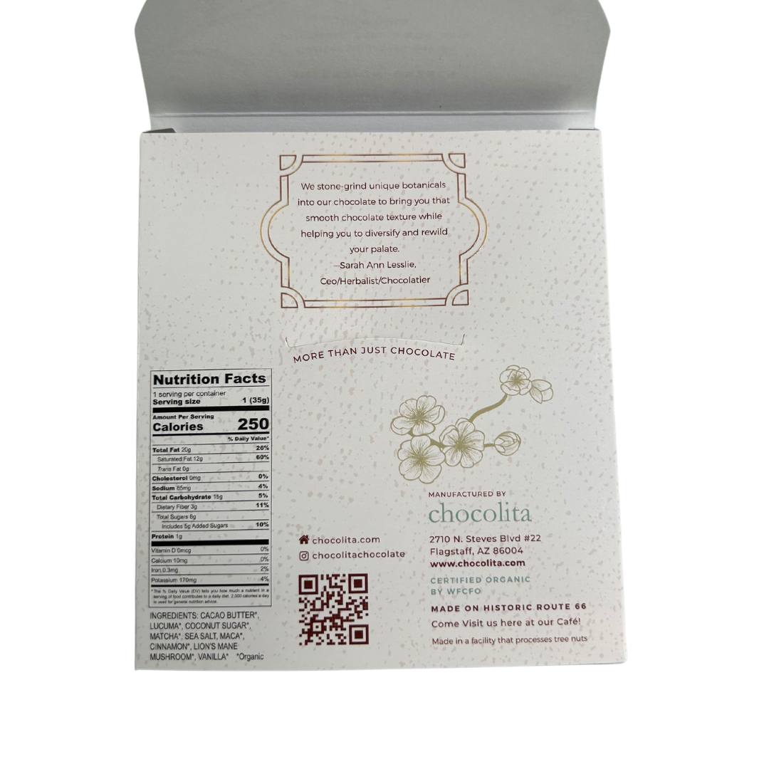 The back of an ENERGY- Morning Matcha box by chocolita.com features a quote, floral art, nutrition facts, ingredients like Raw White Chocolate, social media links, a QR code, and the company address in Flagstaff, Arizona.