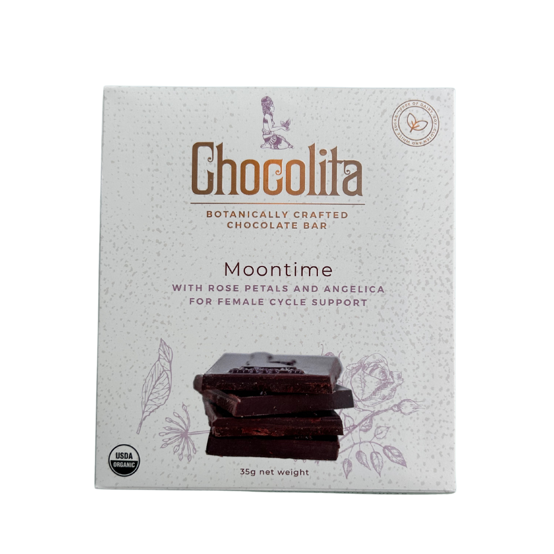 A box of EASE- Moontime Rose by chocolita.com, with botanical graphics and stacked chocolate pieces. The label highlights hormone-balancing rose petals and angelica as key herbs supporting the female cycle.