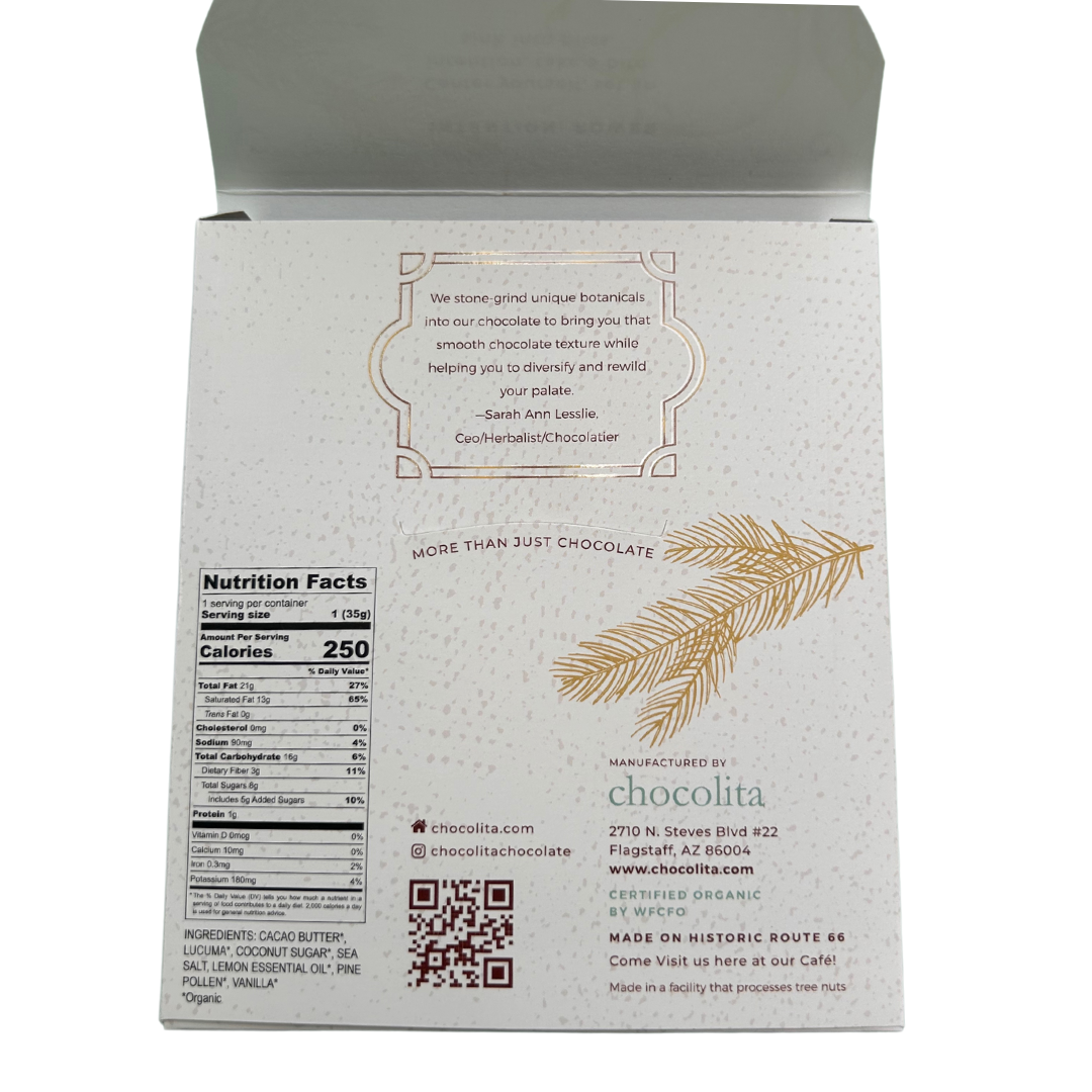 Back of chocolita.coms POWER—Pine Pollen & Lemon bar shows a quote, gold pine branch art, nutrition facts, company info, social media handles & QR code on a speckled white background—highlighting our raw superfood white chocolate.