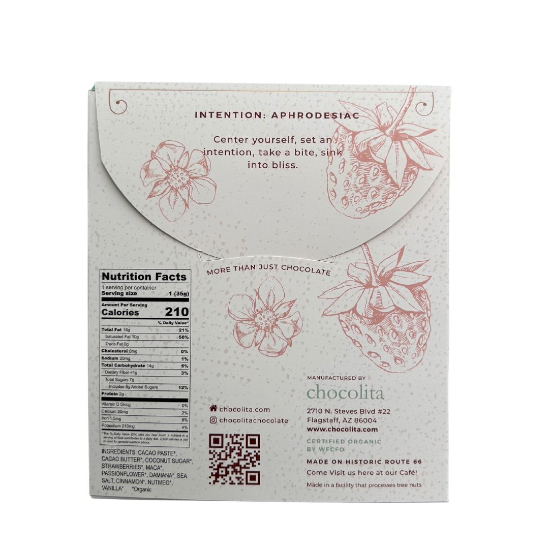 Back of chocolita.com’s APHRODISIA- Strawberry Passion box displays strawberry and cacao flower art, plus aphrodisia herbs. Features nutrition facts, social media links, and an intention-setting message. Pale with reddish-brown illustrations.