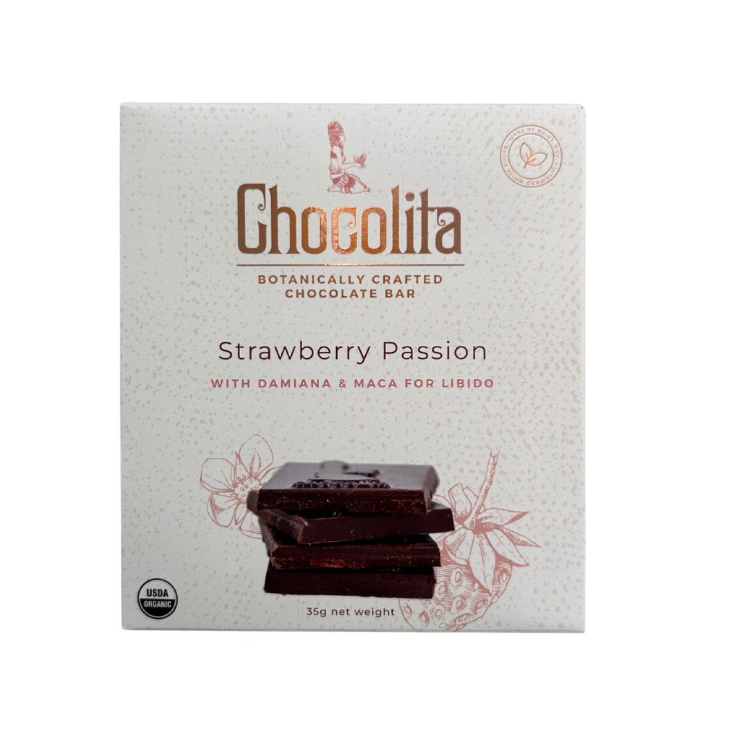 A box of chocolita.com APHRODISIA- Strawberry Passion Raw dark chocolate bar, featuring stacked chocolate graphics, maca and aphrodisia herbs for libido, and a mostly white design with brown and red accents.