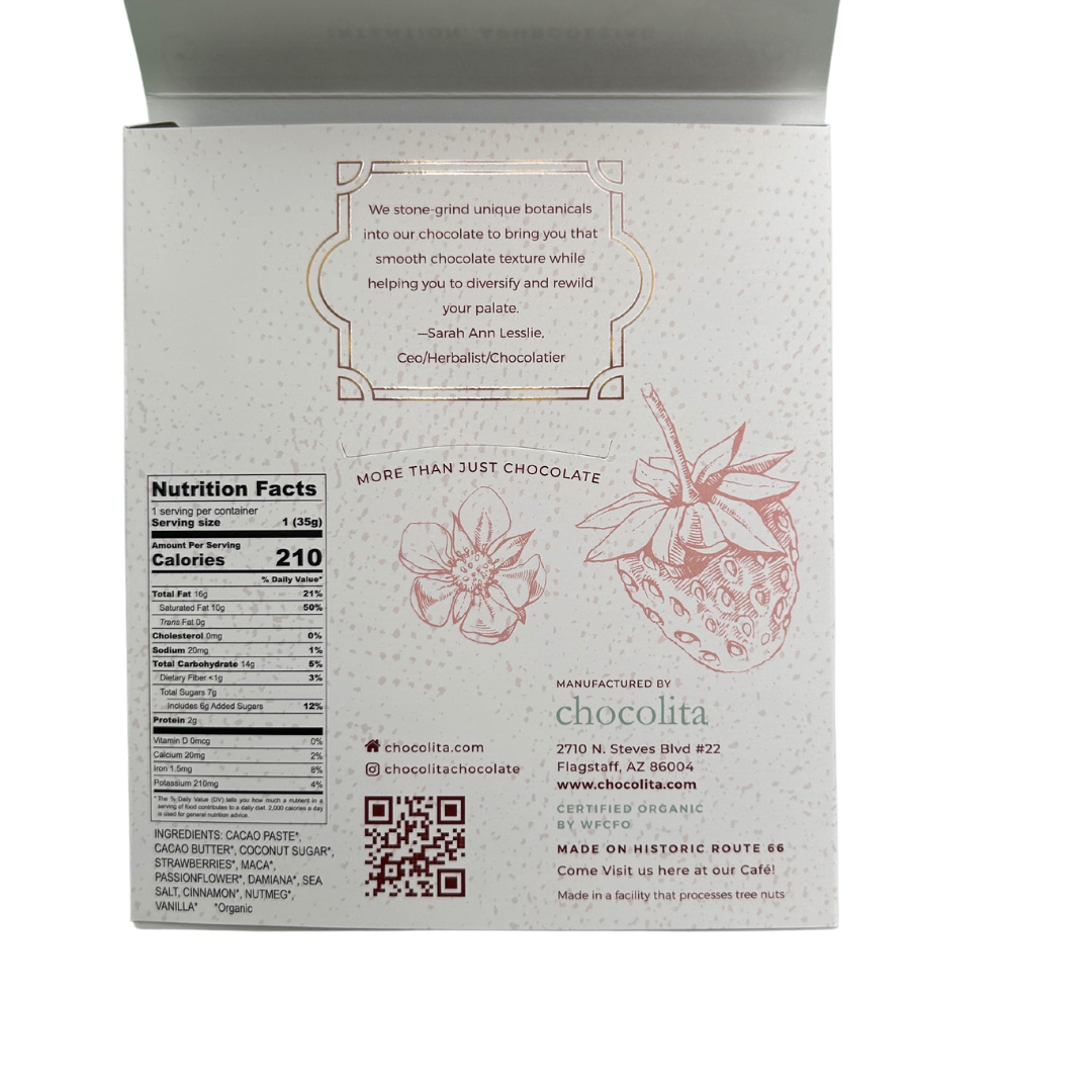 Back of APHRODISIA - Strawberry Passion by chocolita.com: shows nutrition facts, a strawberry and flower illustration, Sarah Ann Lesslie quote, Chocolita’s details, aphrodisia herbs & maca info, plus social media links on a light background.
